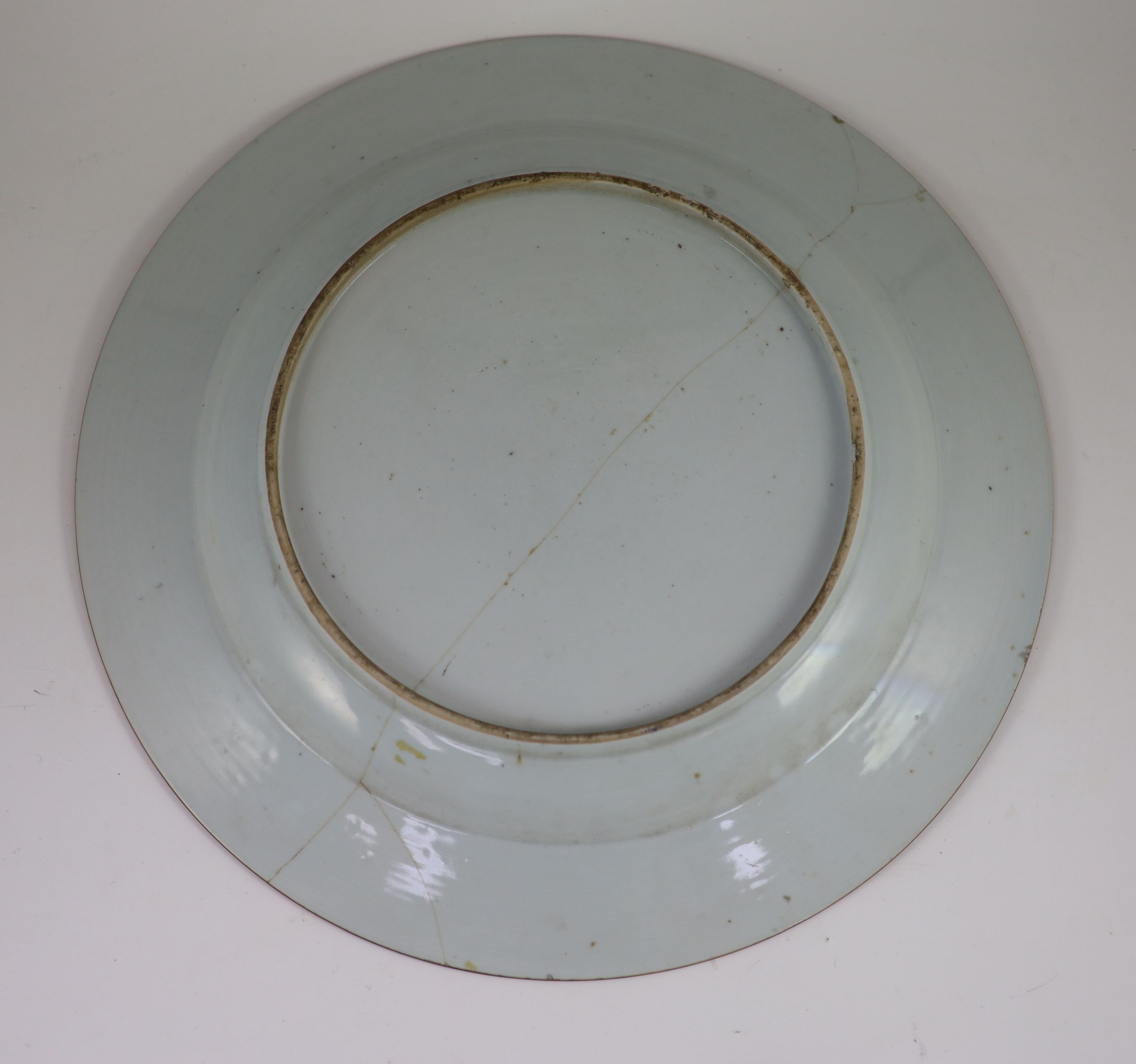 A pair of Chinese export famille rose dishes and a similar charger, early Qianlong period, diameter 35 cm and 42 cm, the charger broken and repaired